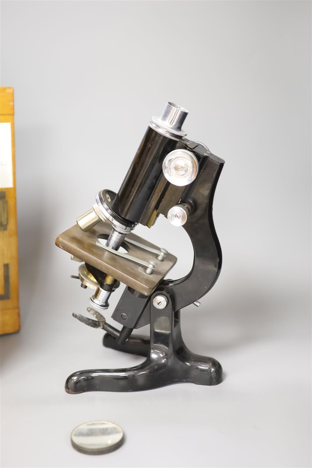 An oak-cased black japanned microscope, case 35cm high, width 16cm, 20cm depth and a brass mantel timepiece